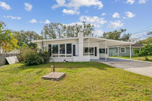 a aerial view of a house with a yard table and chairs