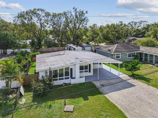 an aerial view of a house with a yard