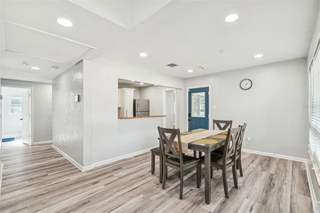 a kitchen with stainless steel appliances kitchen island granite countertop a kitchen island a stove a dining table and chairs