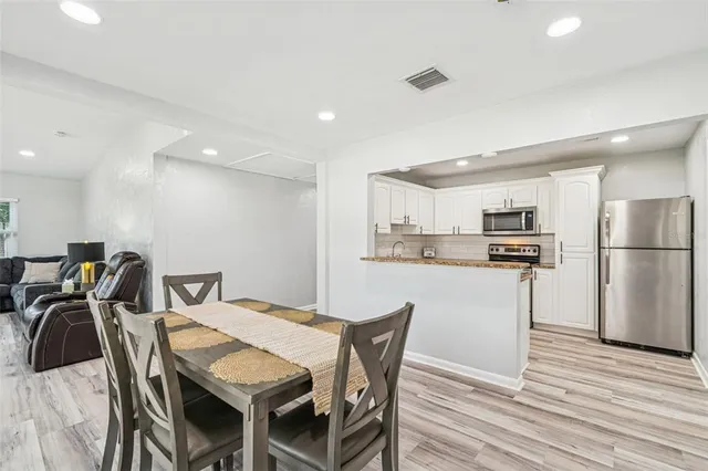 a kitchen with stainless steel appliances granite countertop a stove top oven a sink and a granite counter tops