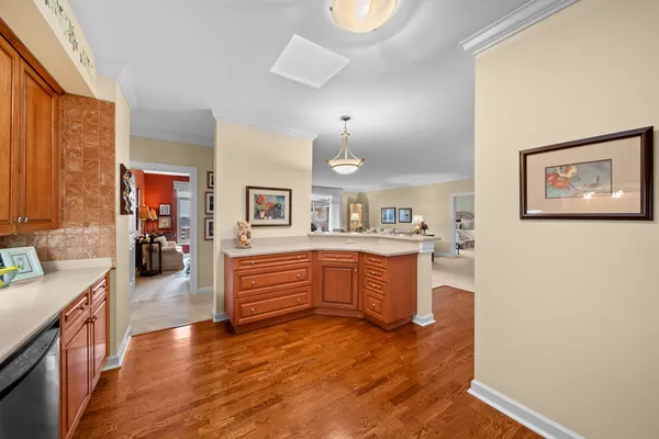 a large kitchen with a lot of counter space and wooden floor