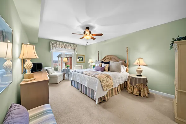 a spacious bedroom with a bed and a chandelier