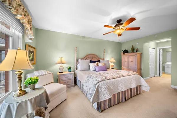 a bedroom with a bed couch and a window