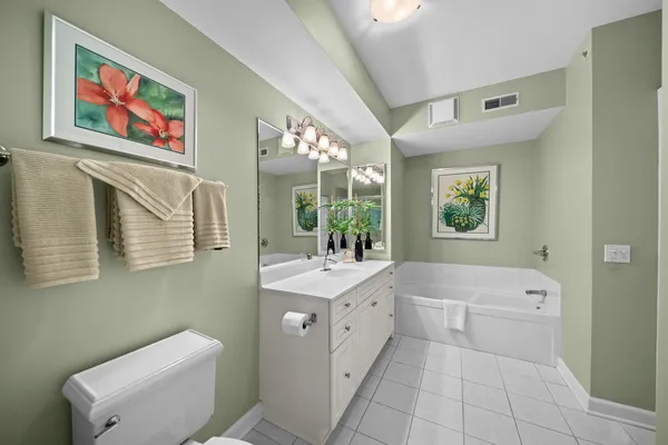 a bathroom with a sink a mirror a toilet and a bathtub