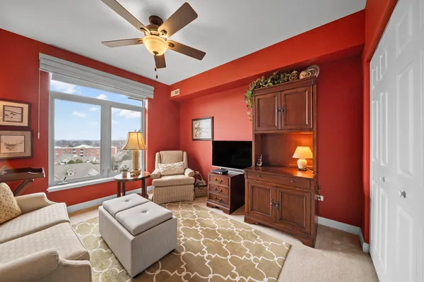 a living room with furniture a chandelier and a flat screen tv