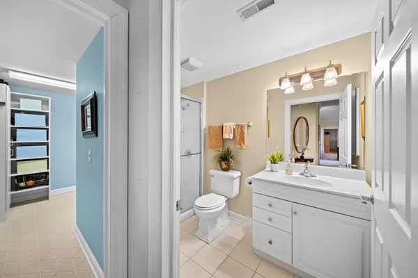a bathroom with a double vanity sink mirror and toilet