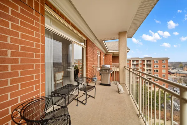 a view of a balcony with chairs