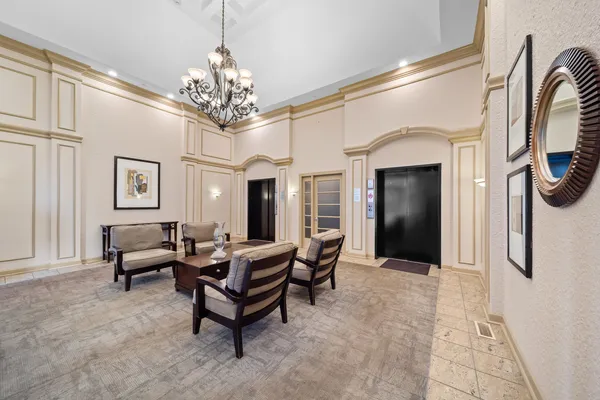 a living room with furniture a chandelier and a chandelier