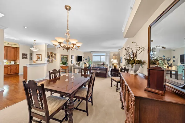 a dining room filled with furniture and a chandelier