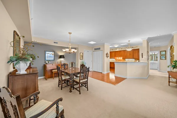 a living room with furniture and a dining table with kitchen view