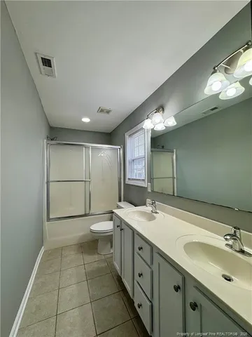 a bathroom with a sink double vanity and a mirror