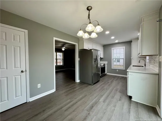 a view of a kitchen with a refrigerator microwave and a sink