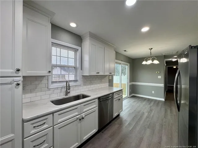 a kitchen with a sink stainless steel appliances and cabinets