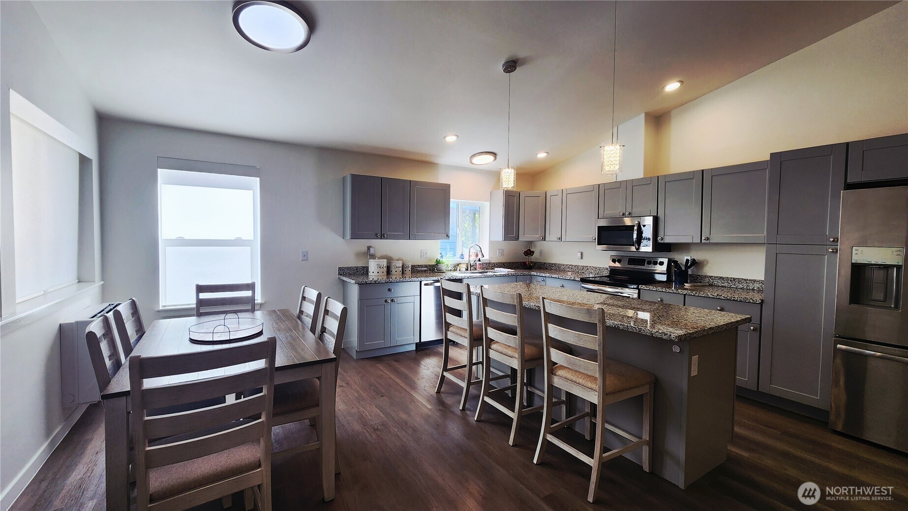 371 Centaurus Avenue Southwest Ocean Shores, WA 98569 - Photo 11 of 40 a kitchen with a table chairs microwave and cabinets