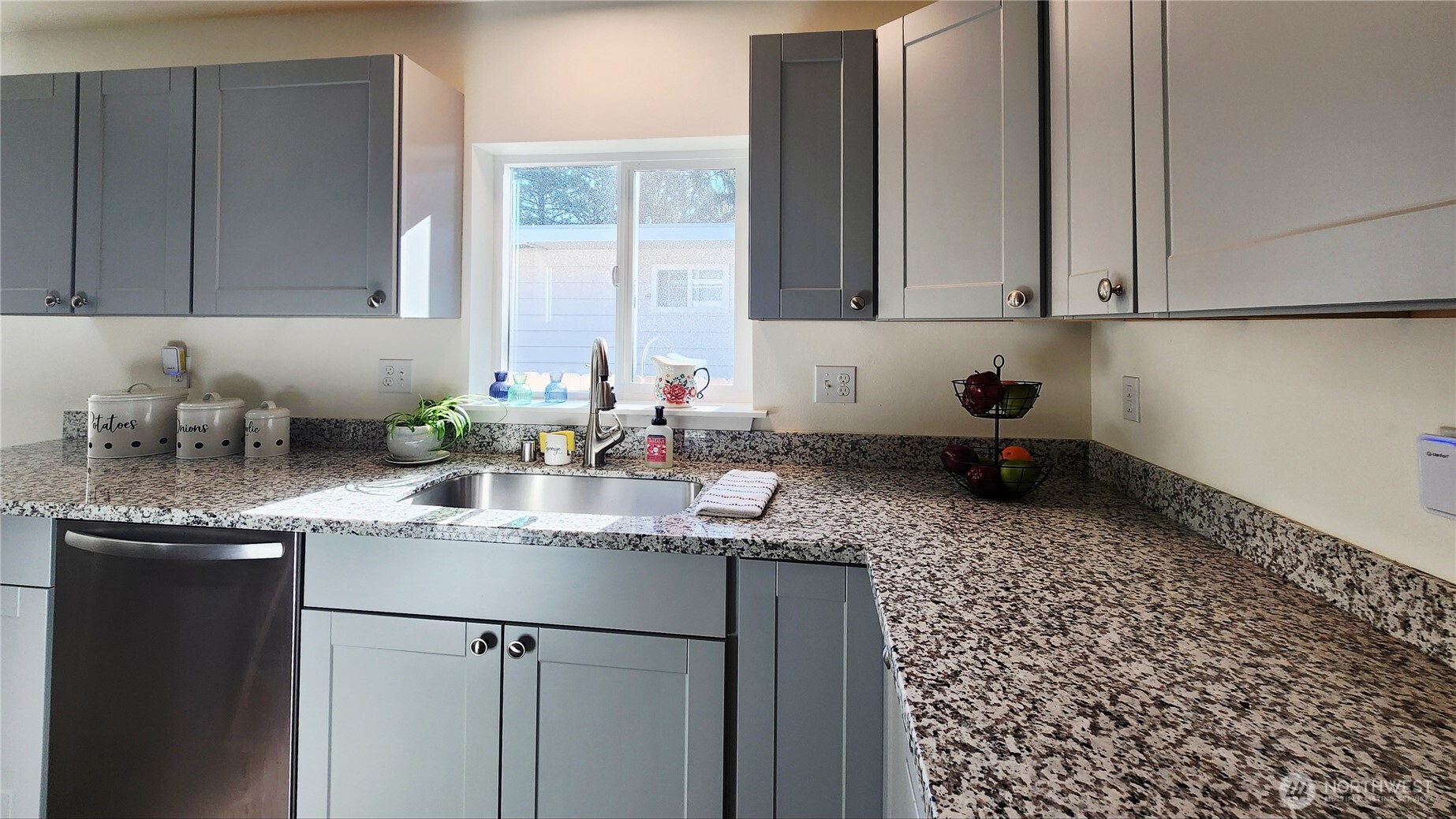 371 Centaurus Avenue Southwest Ocean Shores, WA 98569 - Photo 12 of 40 a kitchen with granite countertop a sink a stove and cabinets