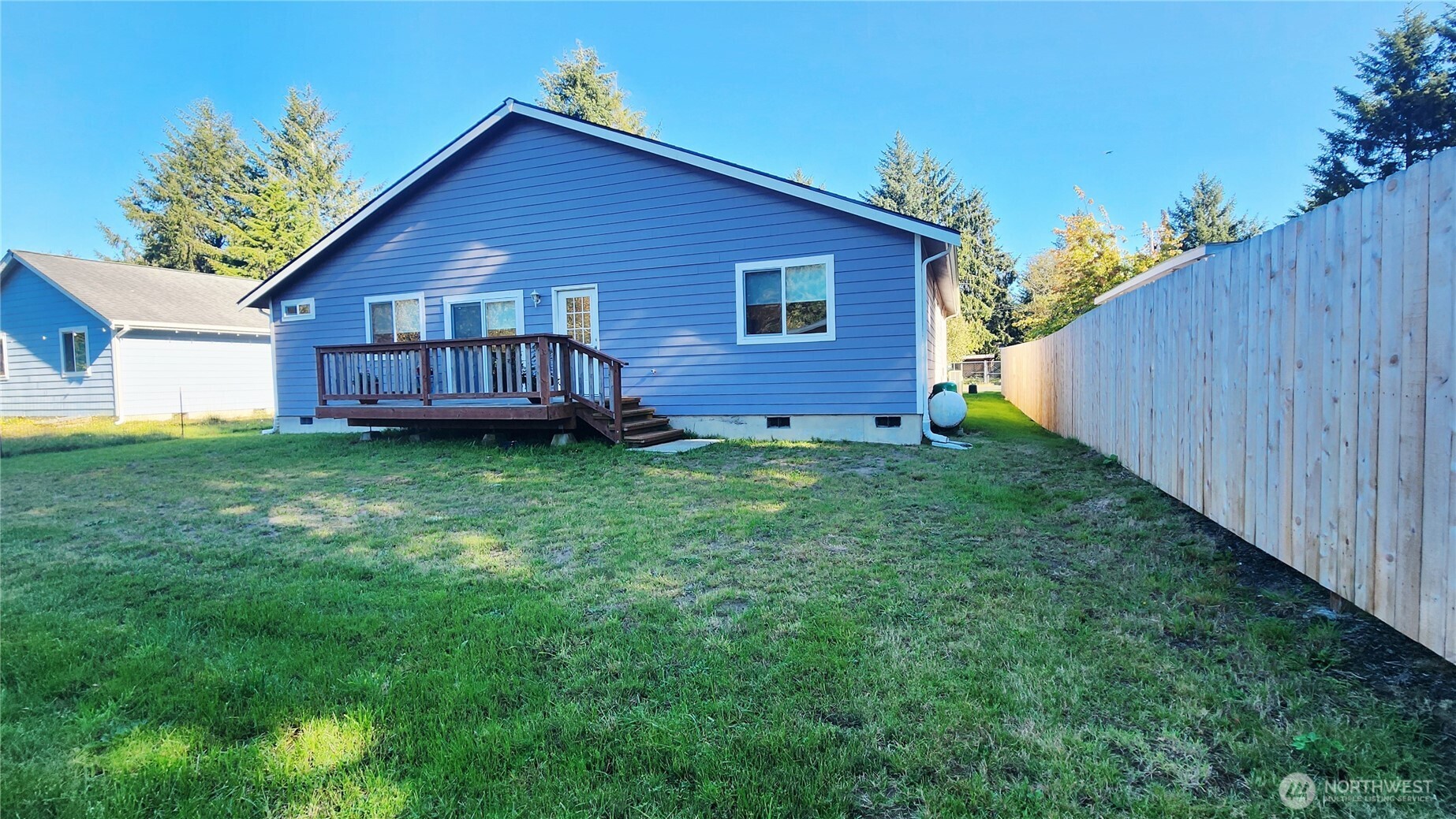 371 Centaurus Avenue Southwest Ocean Shores, WA 98569 - Photo 38 of 40 a view of a house with a yard and wooden fence