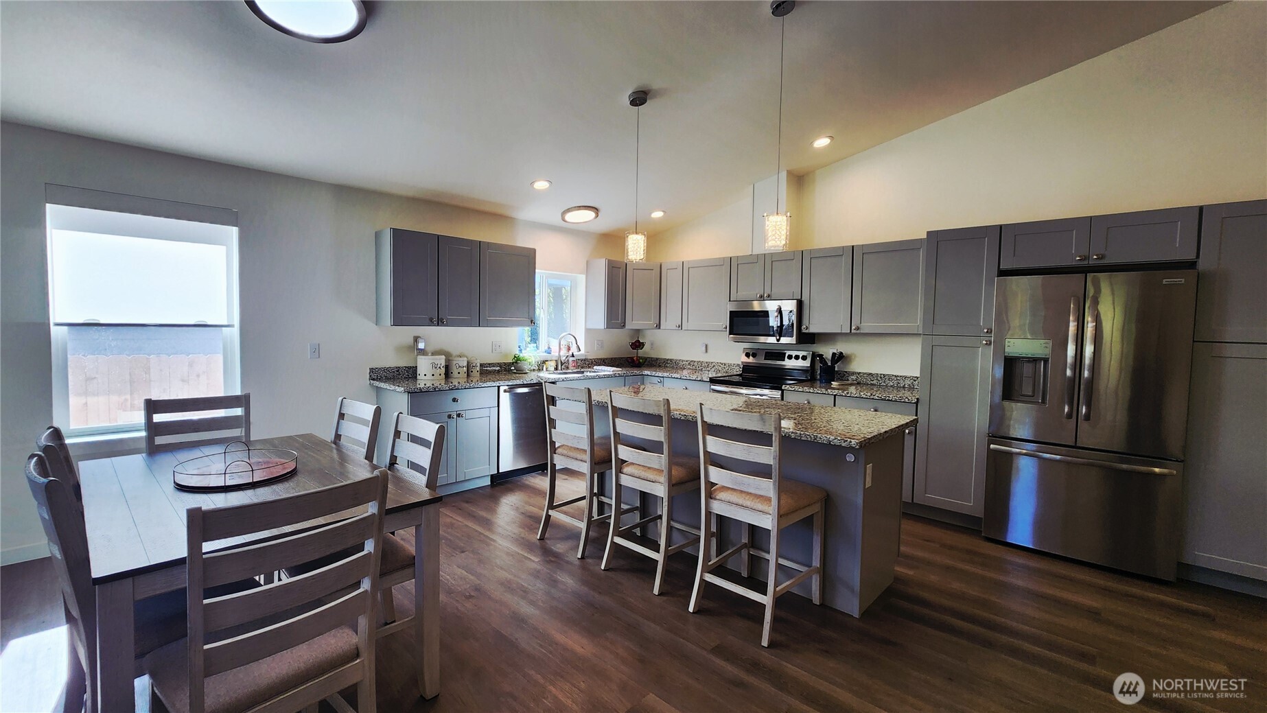 371 Centaurus Avenue Southwest Ocean Shores, WA 98569 - Photo 5 of 40 a kitchen with kitchen island wooden floors appliances and a center island