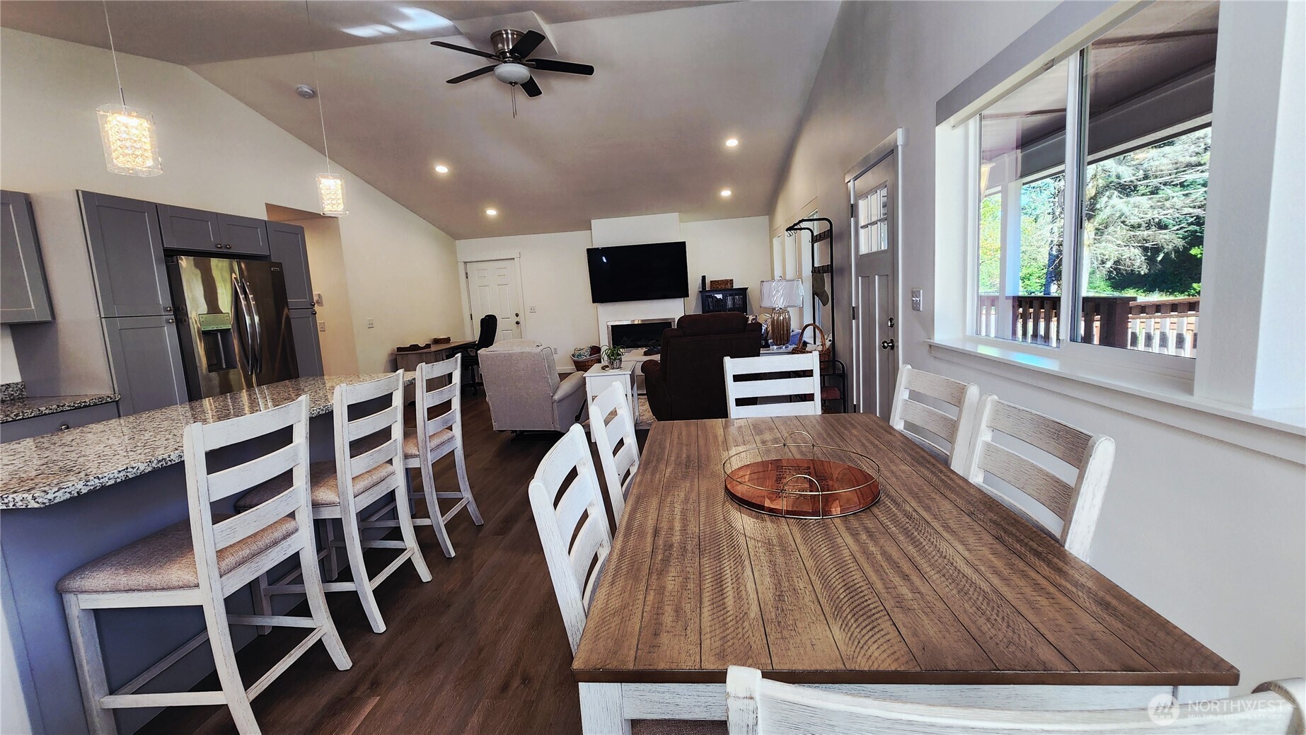371 Centaurus Avenue Southwest Ocean Shores, WA 98569 - Photo 6 of 40 a living room with dining table wooden floor and a floor to ceiling window
