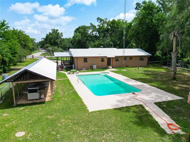 a view of a swimming pool with a bench in the patio