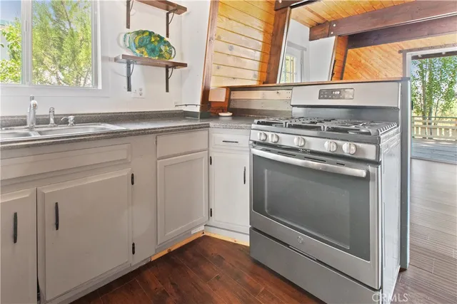 a kitchen with white cabinets and appliances