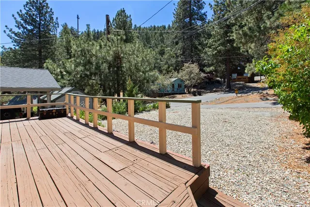 a view of balcony with wooden floor and outdoor seating