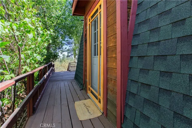 a view of balcony with wooden floor and fence