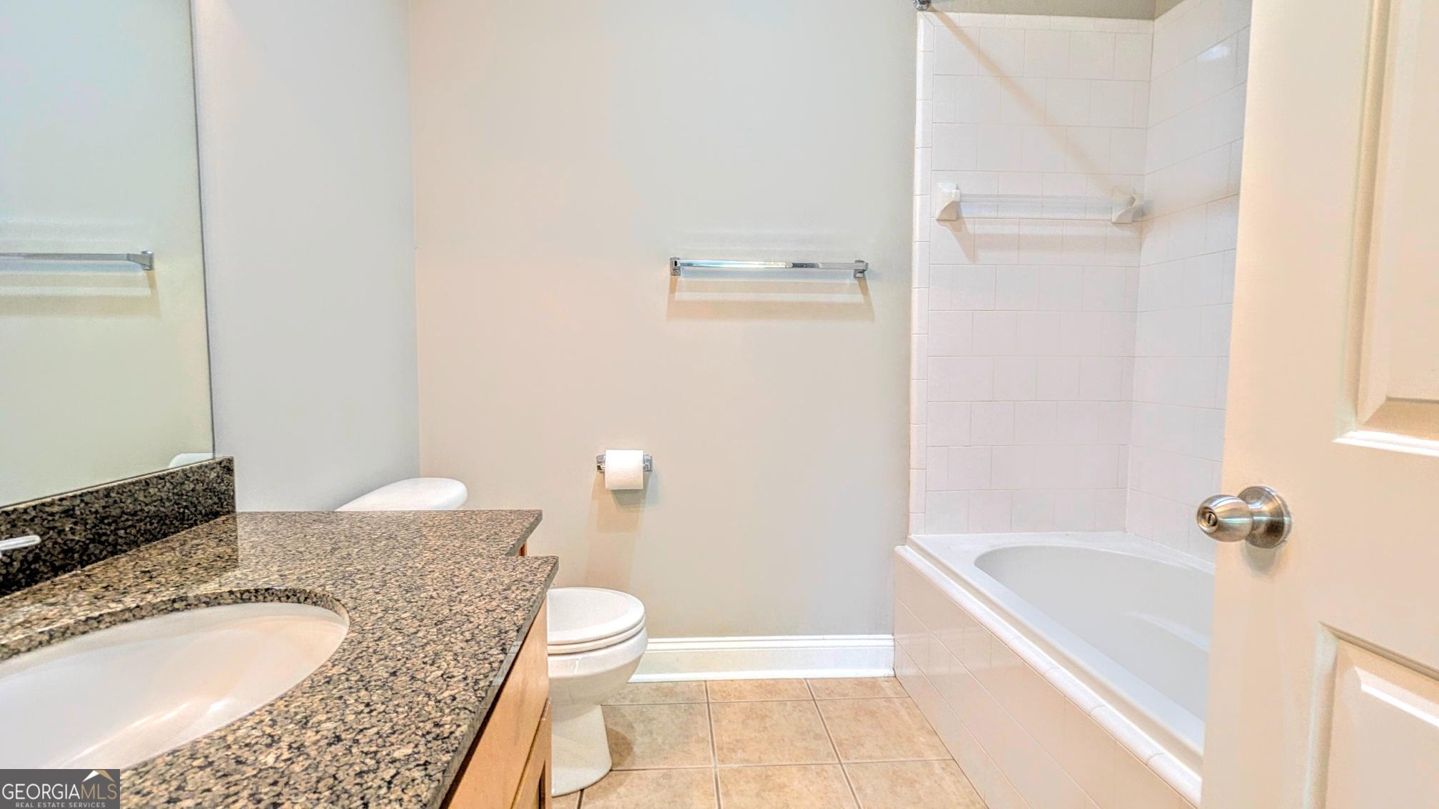 1500 Timothy Road, Unit A4 Athens, GA 30606 - Photo 21 of 35 a bathroom with a granite countertop sink and a mirror