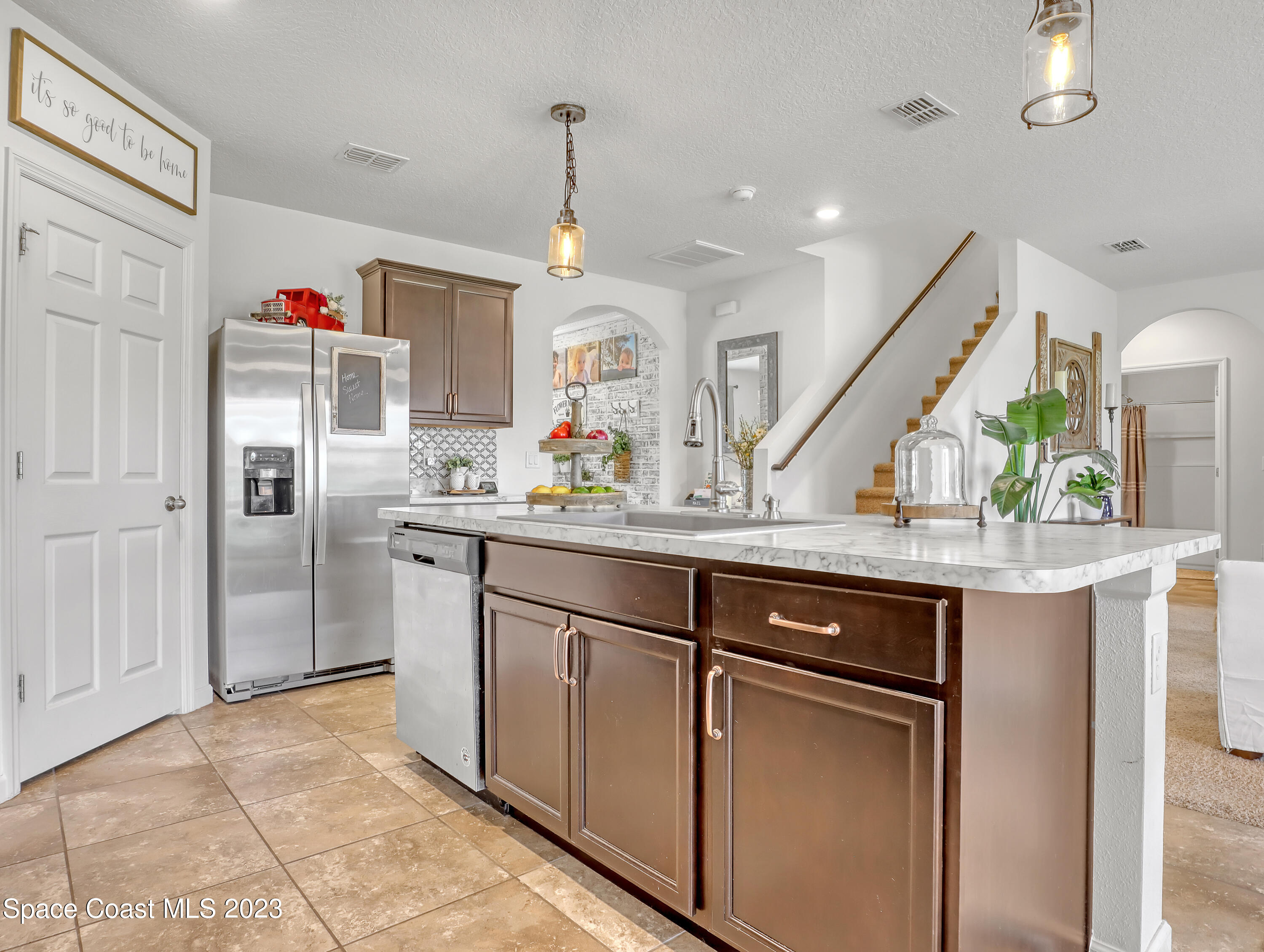 1652 Saxton Road Cocoa, FL 32926 - Photo 11 of 53 a kitchen with stainless steel appliances granite countertop a sink and a refrigerator
