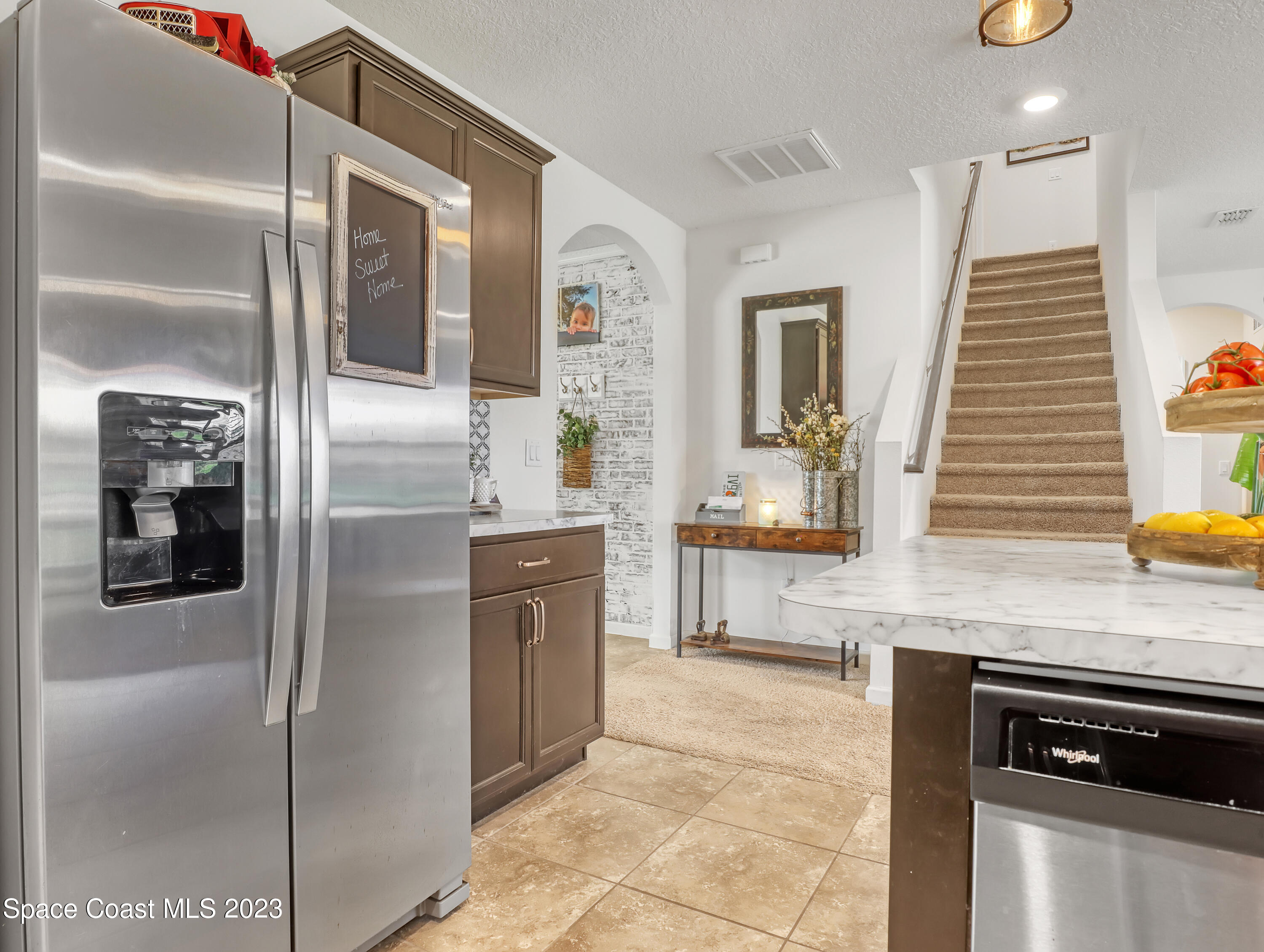 1652 Saxton Road Cocoa, FL 32926 - Photo 12 of 53 a kitchen with stainless steel appliances granite countertop a refrigerator and a sink