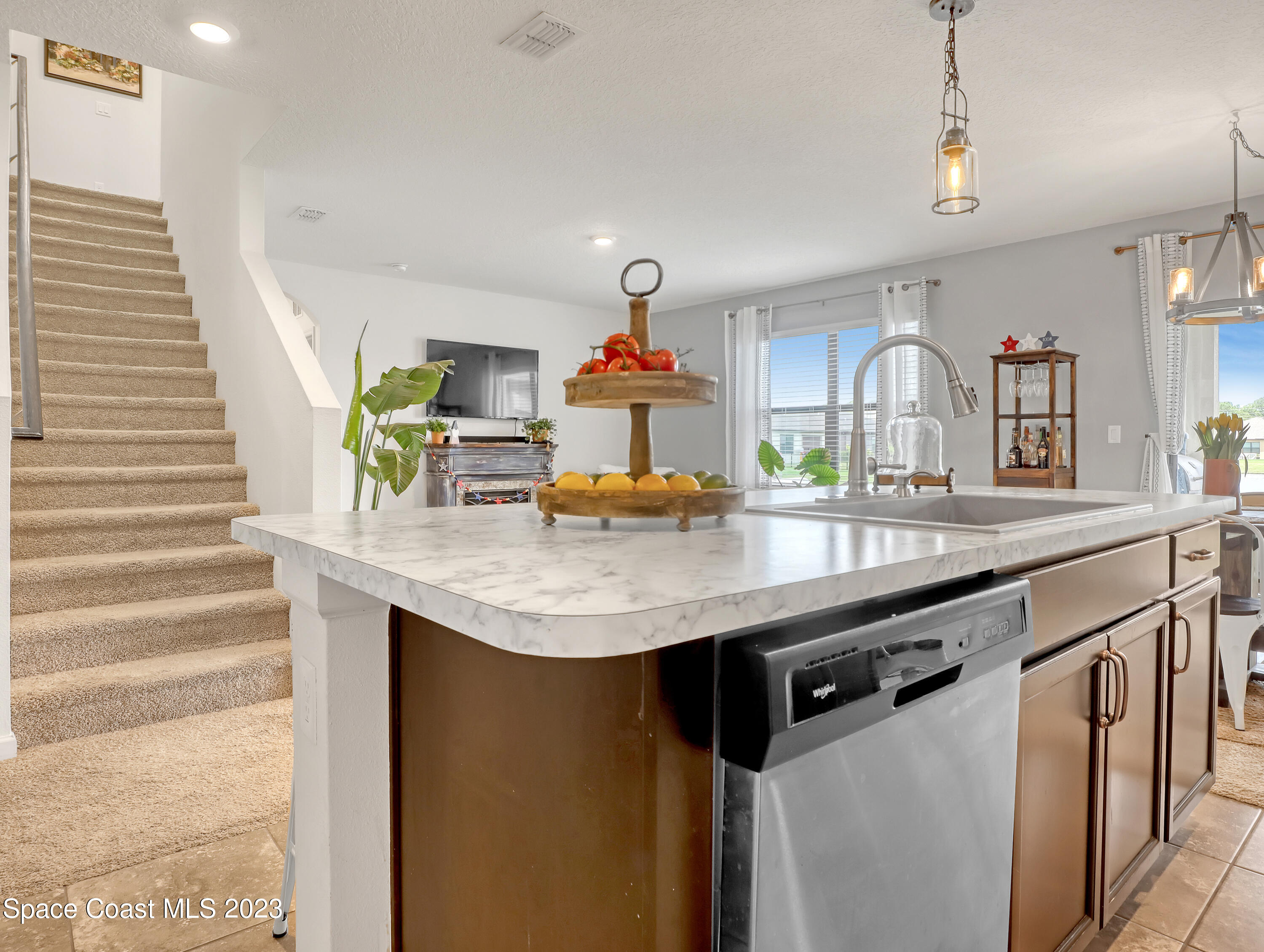 1652 Saxton Road Cocoa, FL 32926 - Photo 13 of 53 a kitchen with stainless steel appliances granite countertop a sink and a refrigerator