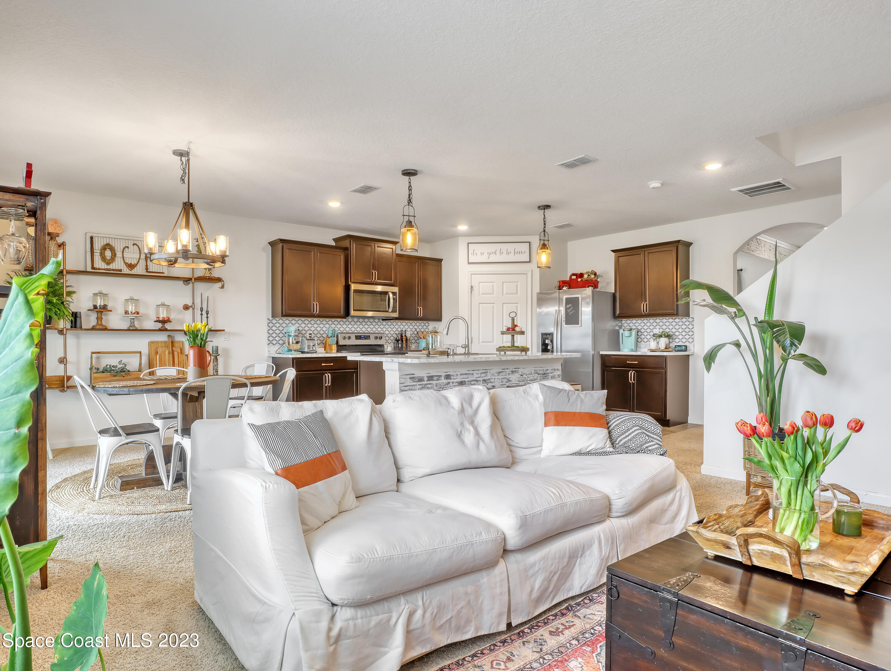 1652 Saxton Road Cocoa, FL 32926 - Photo 20 of 53 a living room with furniture kitchen view and a chandelier