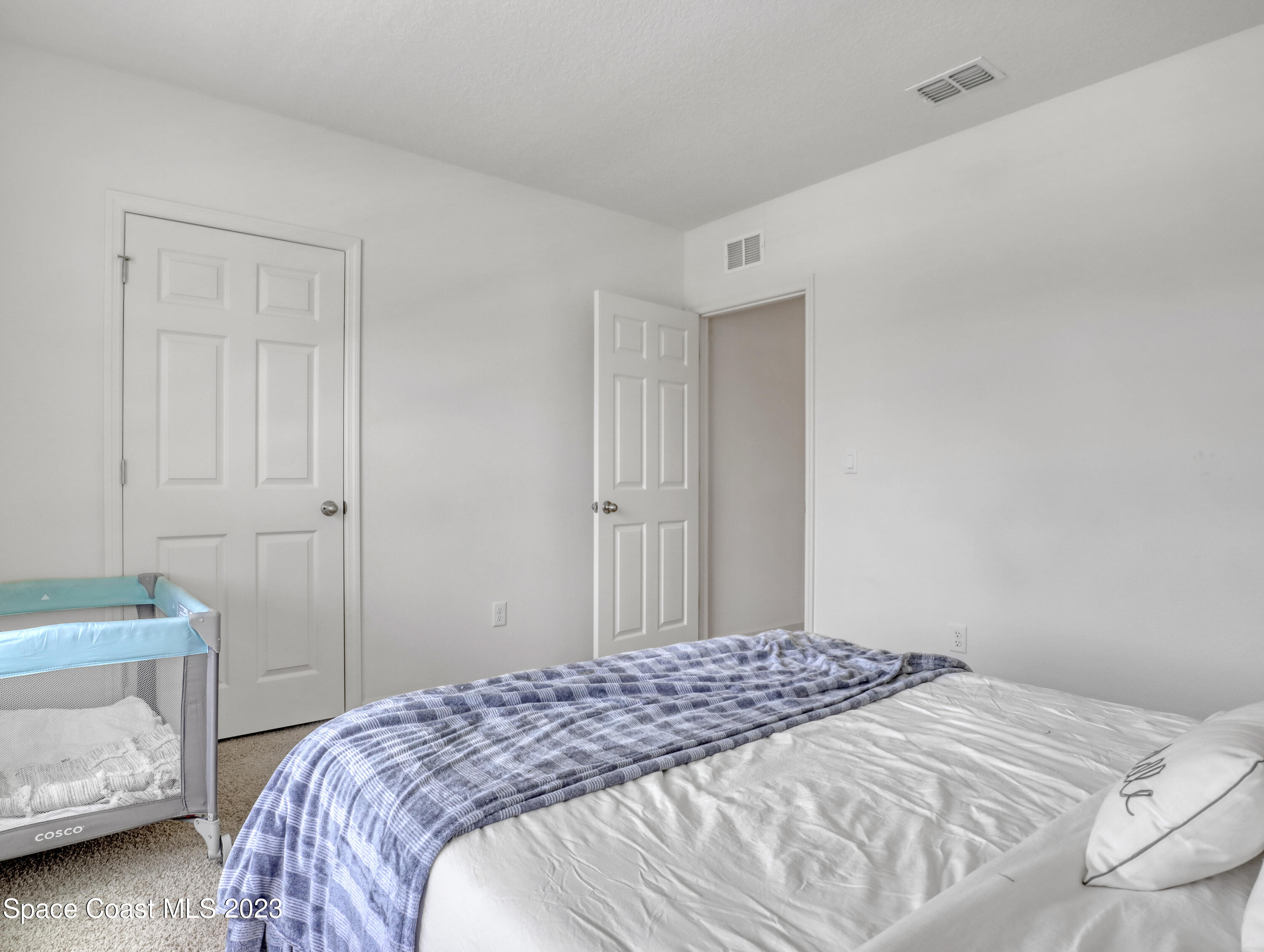 1652 Saxton Road Cocoa, FL 32926 - Photo 40 of 53 a bedroom with a bed and a lamp