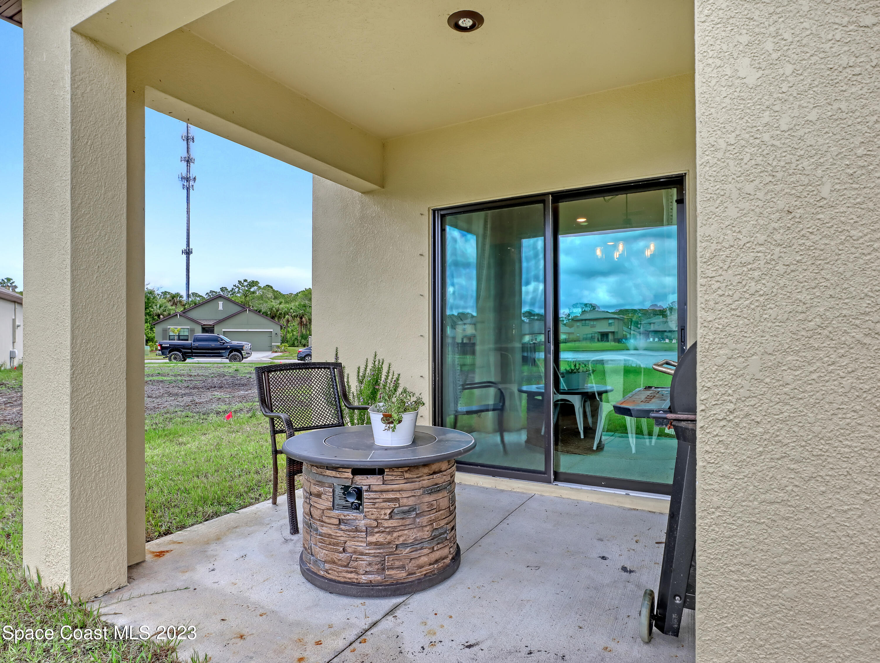 1652 Saxton Road Cocoa, FL 32926 - Photo 43 of 53 a outdoor room with chairs and a garden