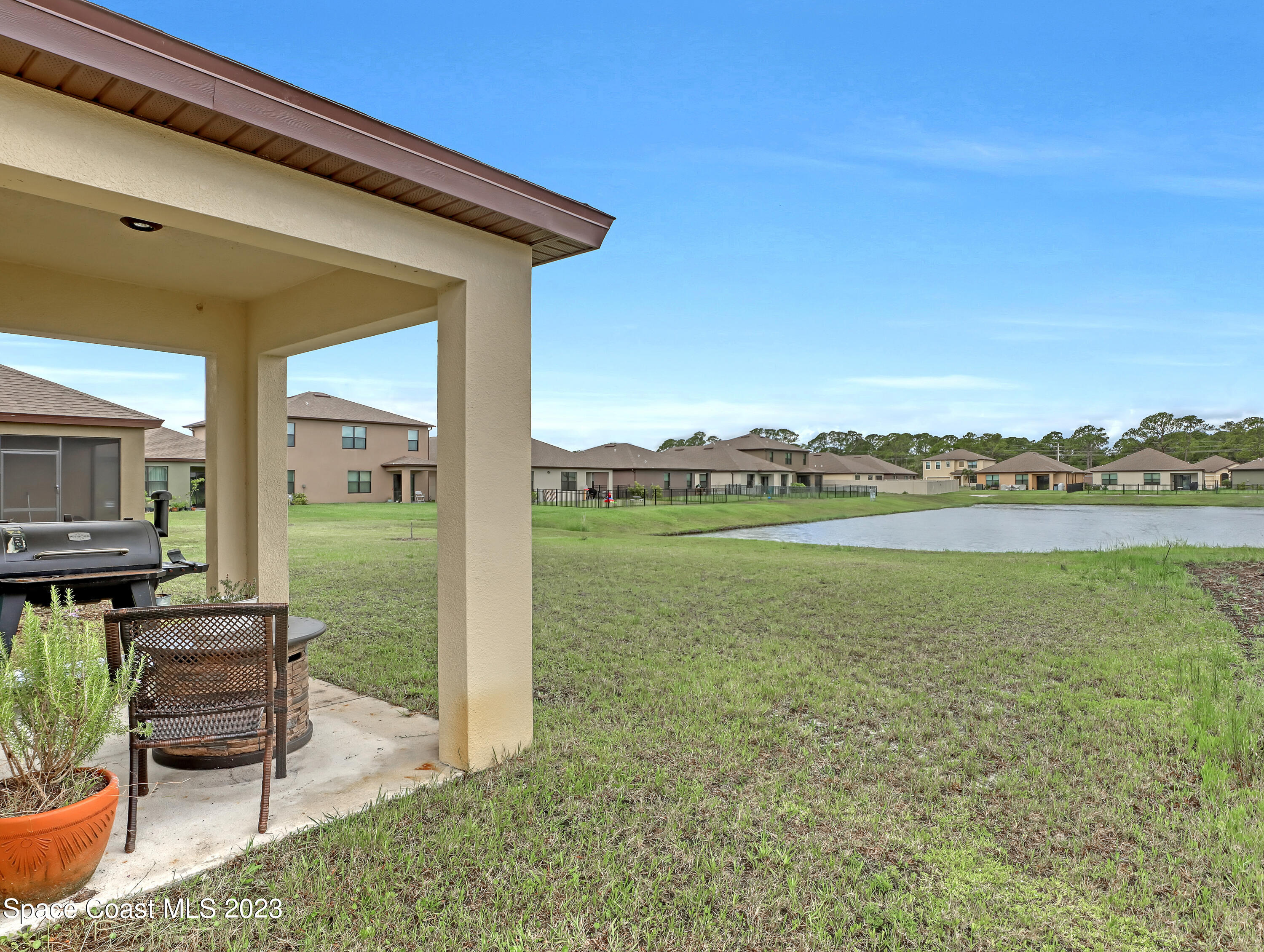 1652 Saxton Road Cocoa, FL 32926 - Photo 47 of 53 a view of a patio with lawn chairs floor to ceiling window and yard