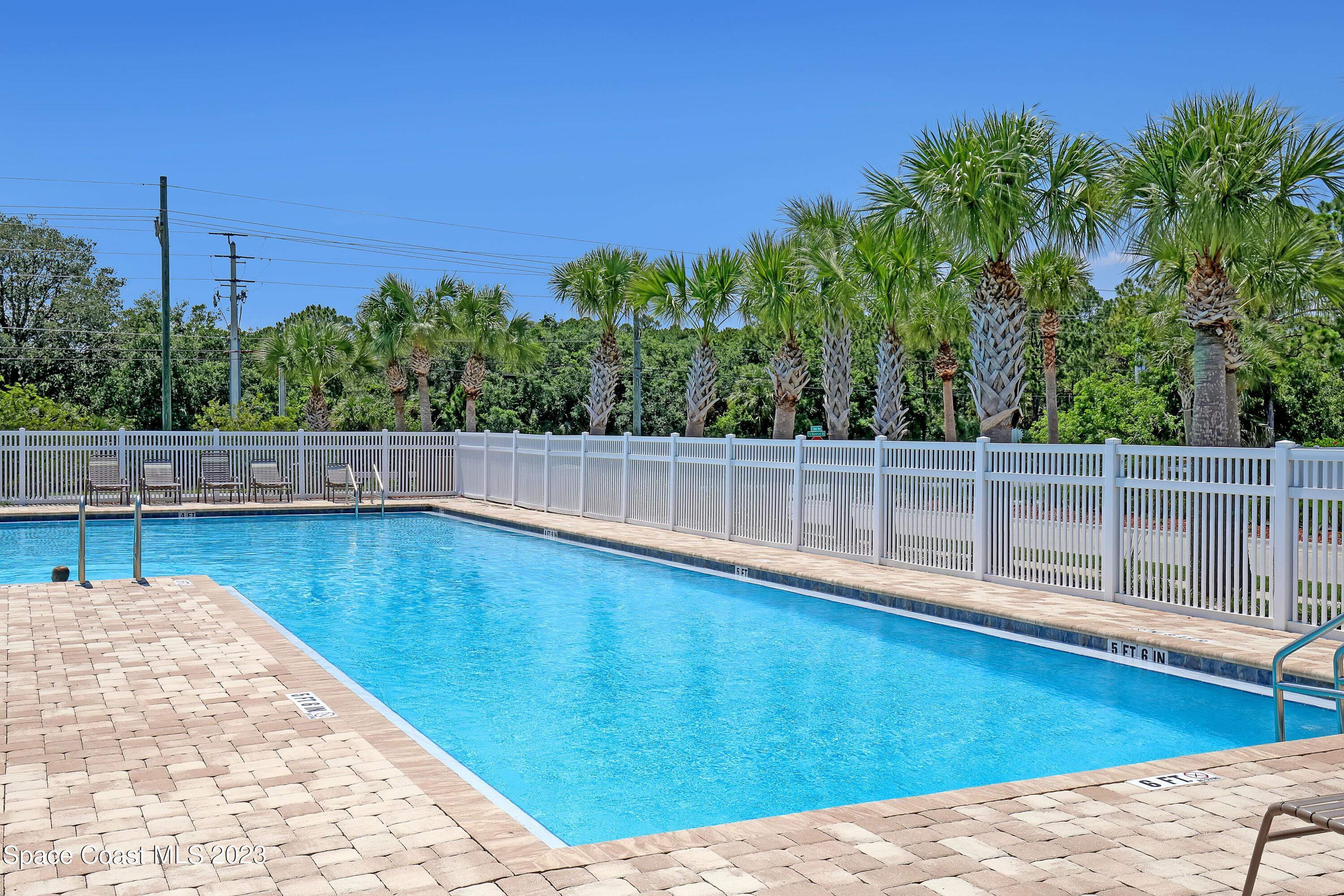 1652 Saxton Road Cocoa, FL 32926 - Photo 51 of 53 a view of outdoor space with swimming pool and trees in the background