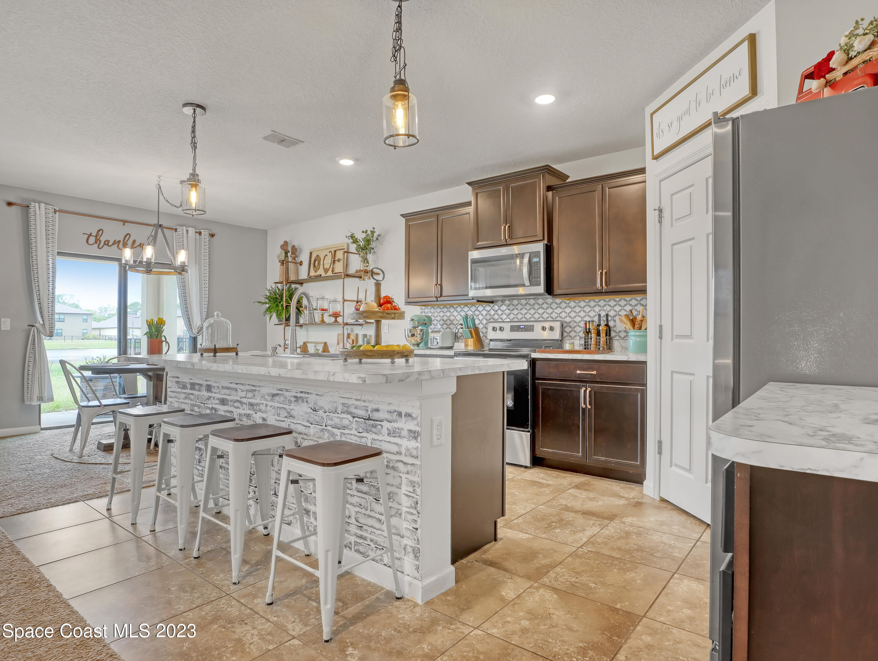 1652 Saxton Road Cocoa, FL 32926 - Photo 8 of 53 a kitchen with kitchen island granite countertop a counter top space appliances and a cabinets