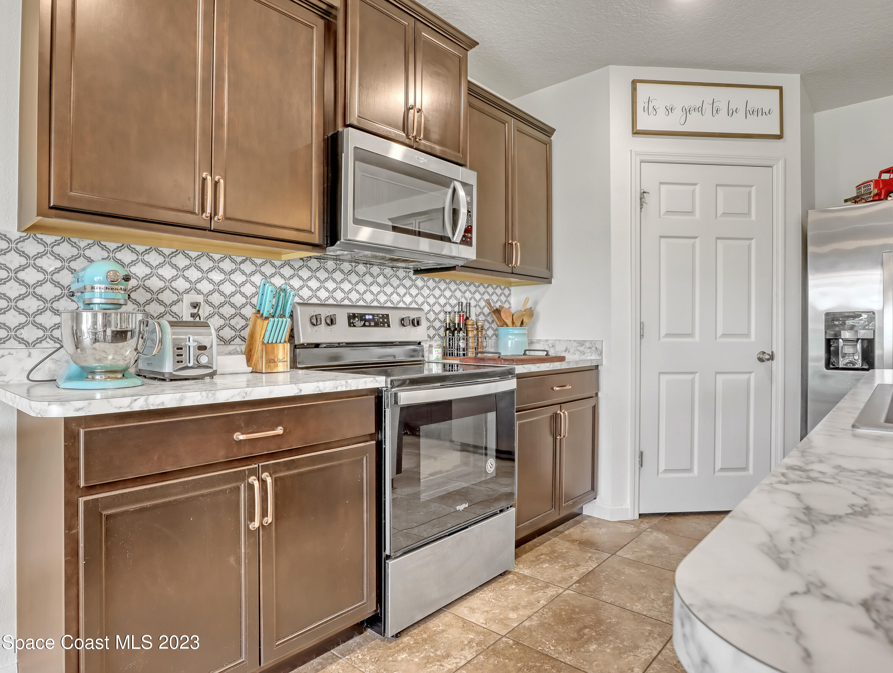 1652 Saxton Road Cocoa, FL 32926 - Photo 10 of 53 a kitchen with stainless steel appliances granite countertop a sink stove and refrigerator