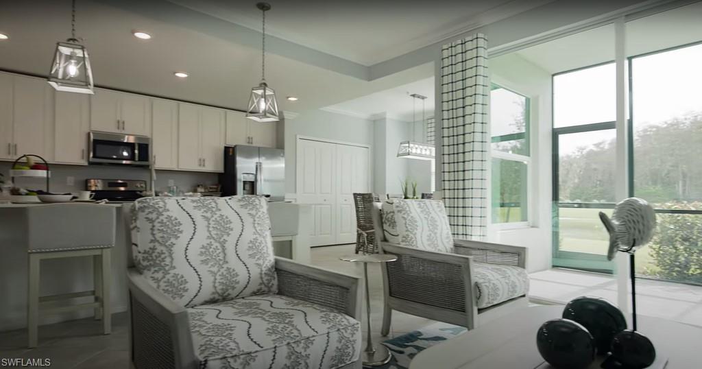 5466 Double Eagle Circle, Unit 3423 Ave Maria, FL 34142 - Photo 11 of 24 Living area featuring crown molding