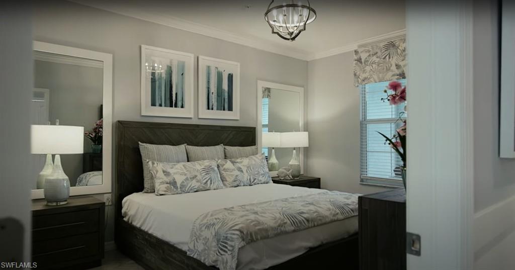 5466 Double Eagle Circle, Unit 3423 Ave Maria, FL 34142 - Photo 13 of 24 Bedroom featuring multiple windows, ornamental molding, and a notable chandelier