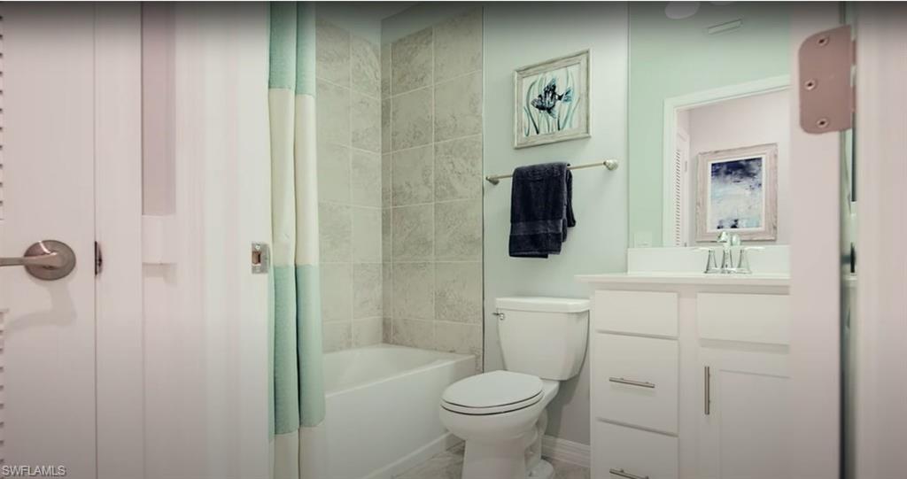 5466 Double Eagle Circle, Unit 3423 Ave Maria, FL 34142 - Photo 17 of 24 Full bathroom with shower / bathtub combination with curtain, vanity, and toilet