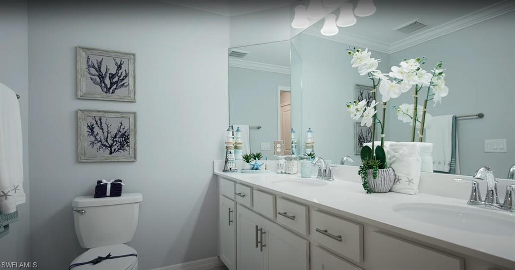 5466 Double Eagle Circle, Unit 3423 Ave Maria, FL 34142 - Photo 19 of 24 Bathroom featuring crown molding, vanity, and toilet