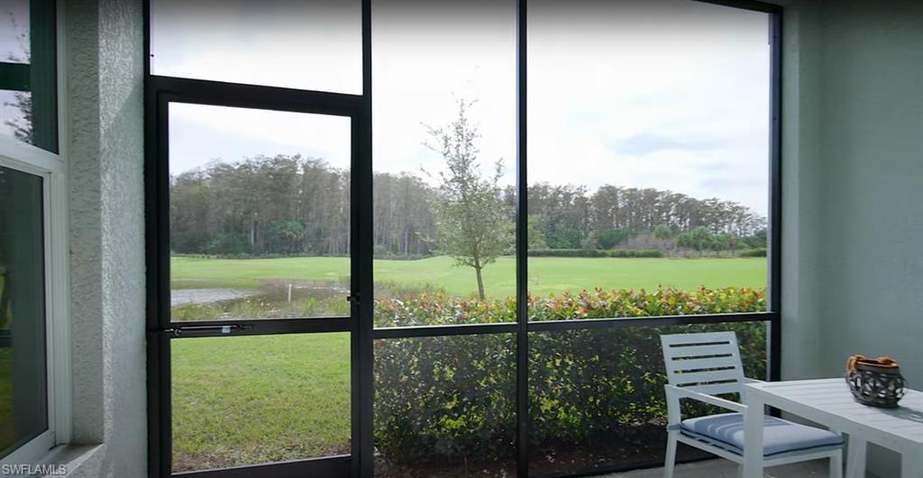 5466 Double Eagle Circle, Unit 3423 Ave Maria, FL 34142 - Photo 20 of 24 Unfurnished sunroom featuring a water view