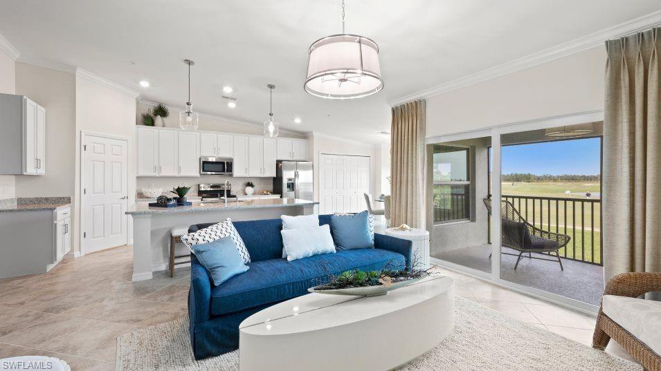 5466 Double Eagle Circle, Unit 3423 Ave Maria, FL 34142 - Photo 6 of 24 Tiled living room featuring vaulted ceiling and ornamental molding