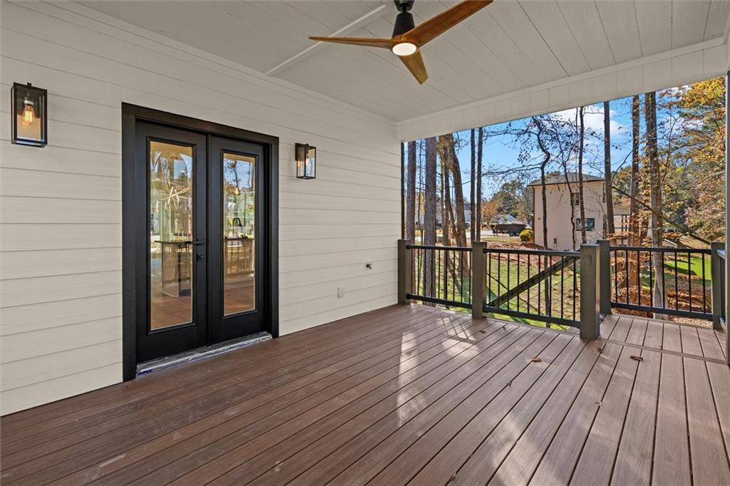 752 Crystal Bay Road Villa Rica, GA 30180 - Photo 16 of 60 a view of a porch with wooden floor and iron stairs