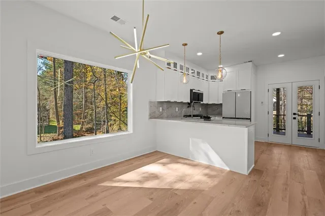 a kitchen with stainless steel appliances a microwave a sink and a refrigerator