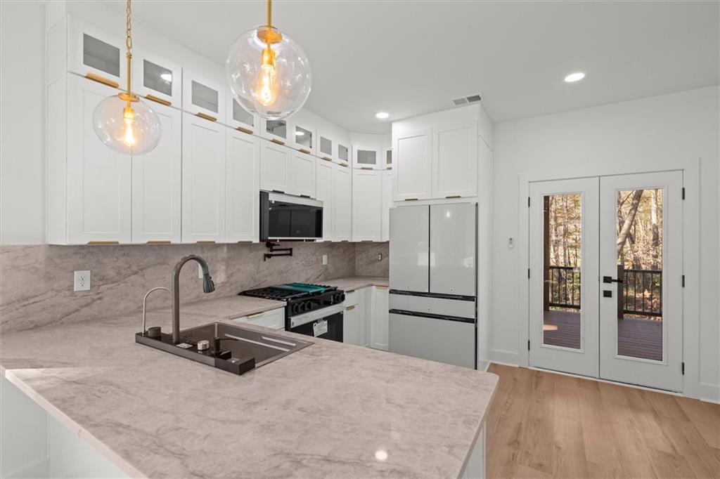 752 Crystal Bay Road Villa Rica, GA 30180 - Photo 9 of 60 a kitchen with stainless steel appliances a microwave a sink and a refrigerator