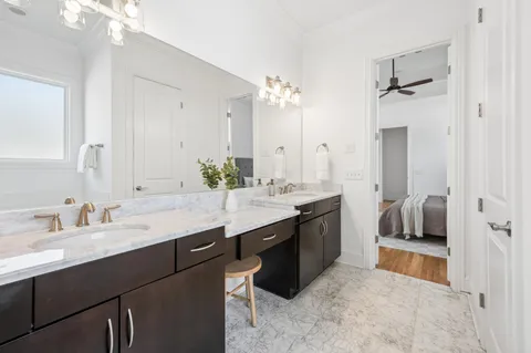a bathroom with a double vanity sink a mirror a shower and a bathtub