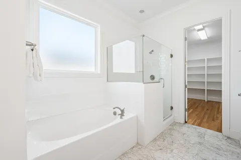 a bathroom with a bathtub and a shower
