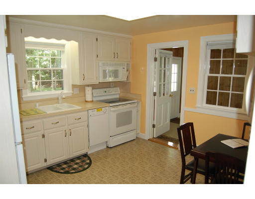 113 Monsen Road Concord, MA 01742 - Photo 2 of 14 a kitchen with a sink cabinets and window