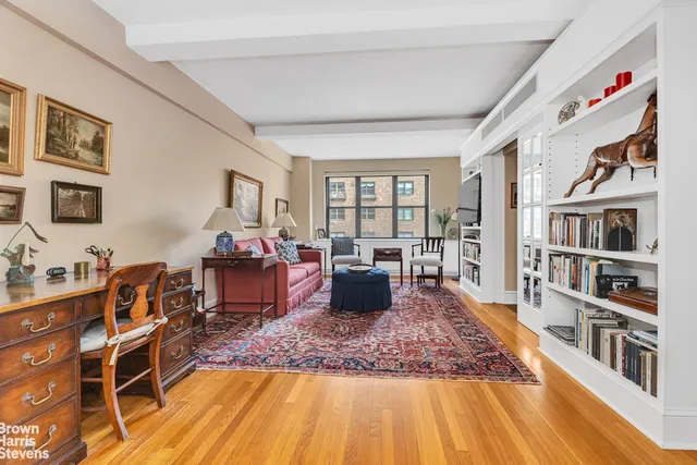 a living room with furniture and a book shelf